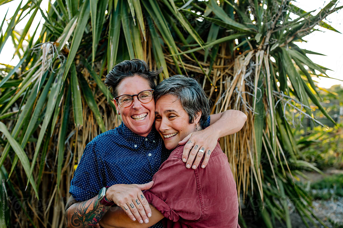 Joyful Lesbian Couple Embracing Outdoors By Stocksy Contributor Erin Brant Stocksy