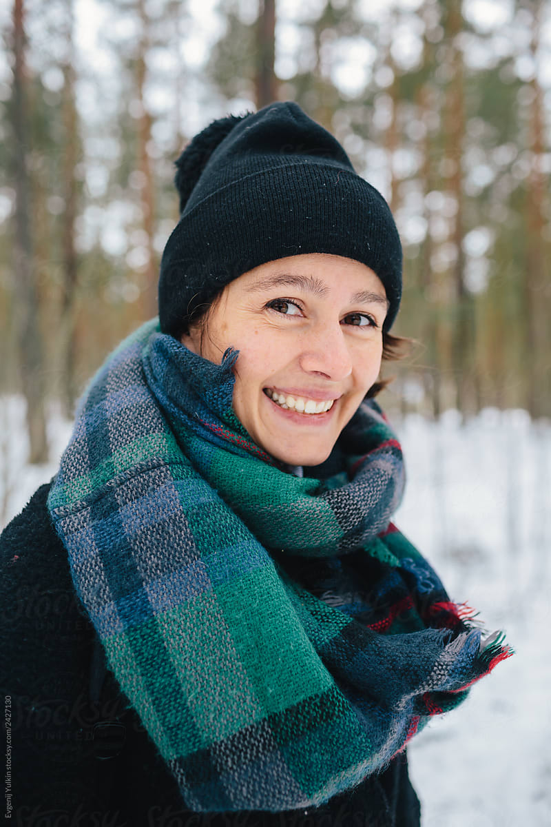 Cheerful young woman in winter forest