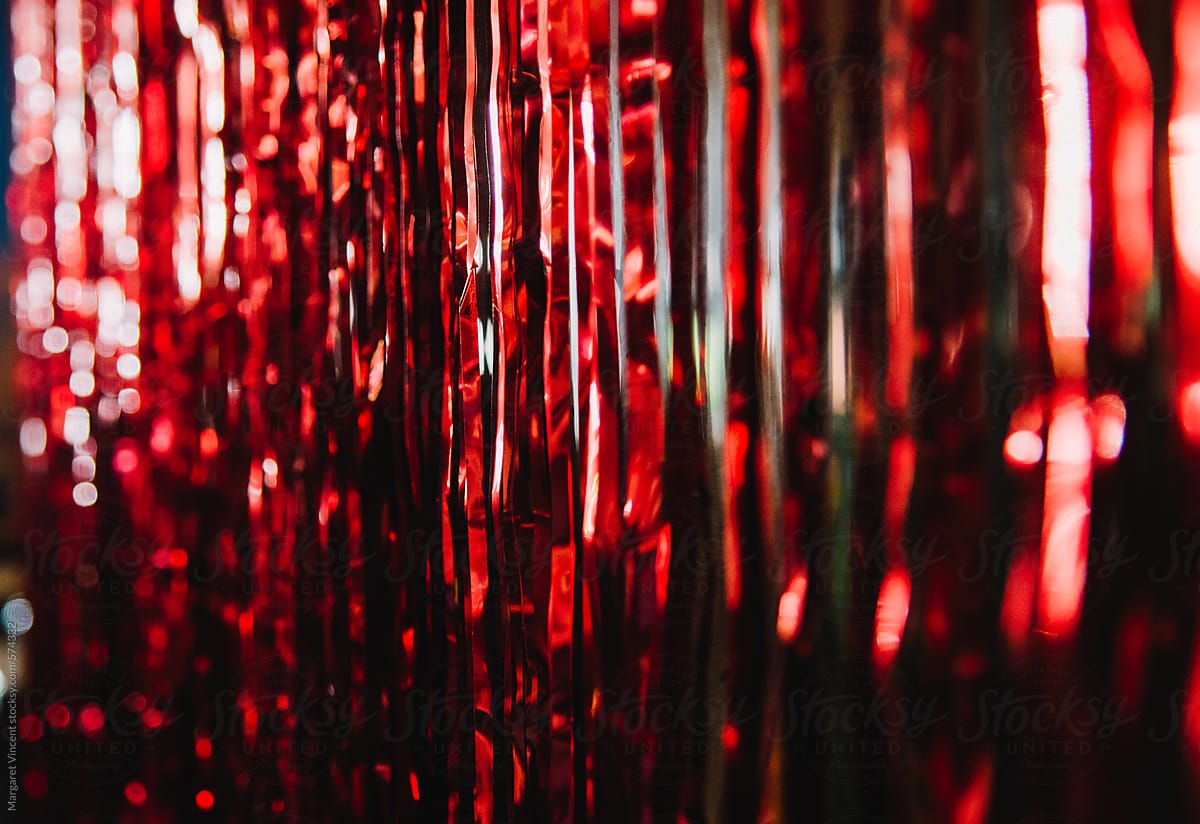 Shimmery Red Streamers by Stocksy Contributor Margaret Vincent