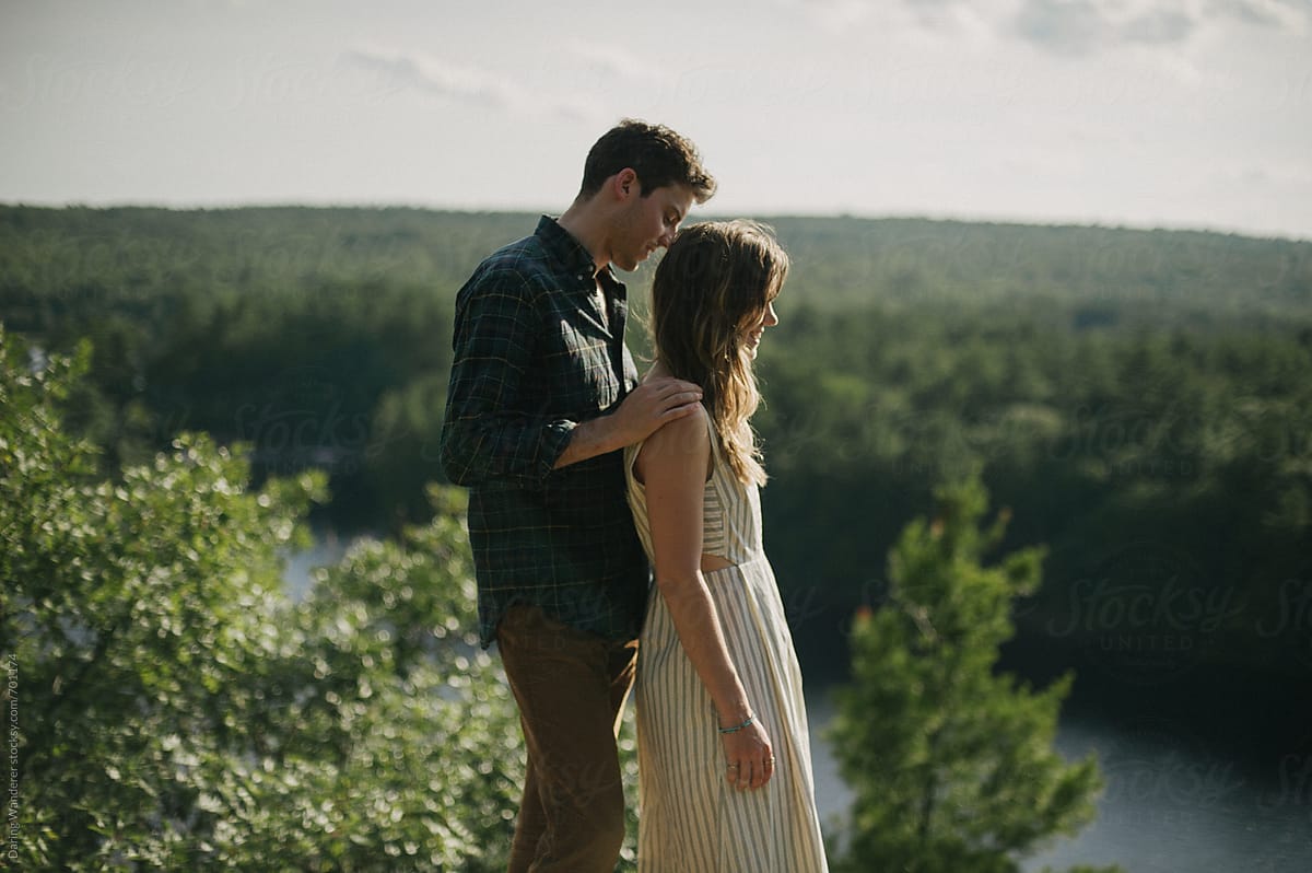 Fun Adventurous Intimate Engaged Couple On Lookout Over Forest