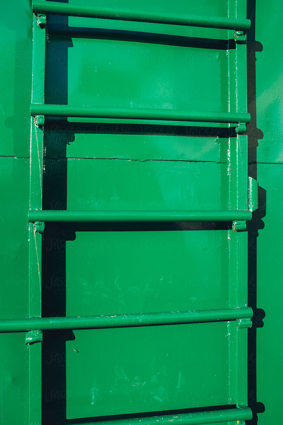 Ladder on green metal container, close up