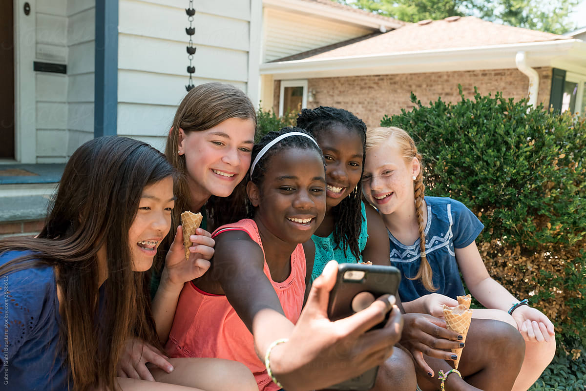 Smiling Girls Taking Selfies By Stocksy Contributor Gabriel Gabi