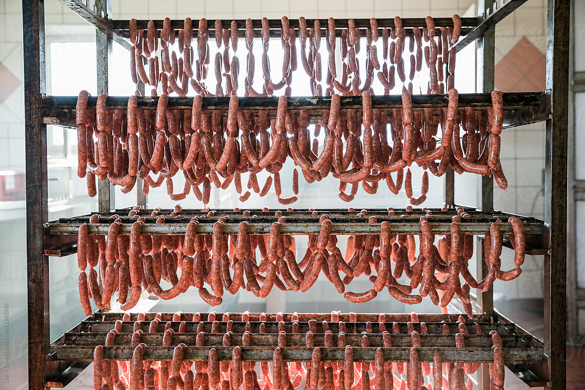 Many linked sausages hanging on mobile rack