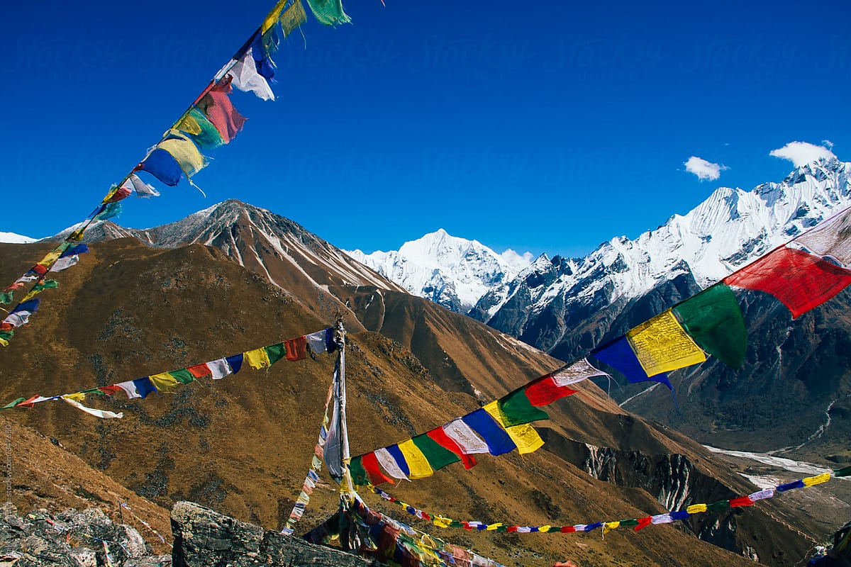 Prayer flags fluttering in the wind high up in the himalayan mountains