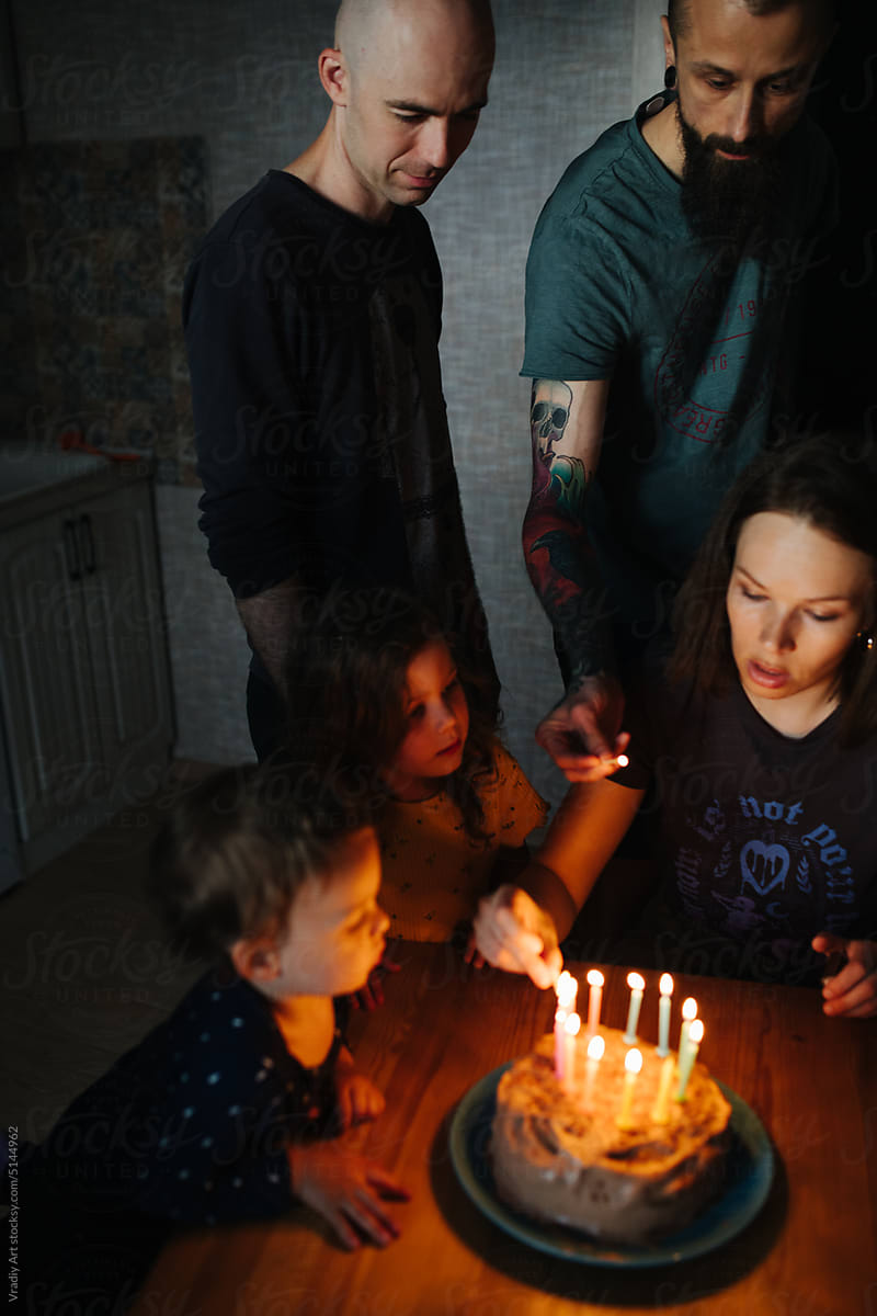Young family with children celebrate a birthday at home