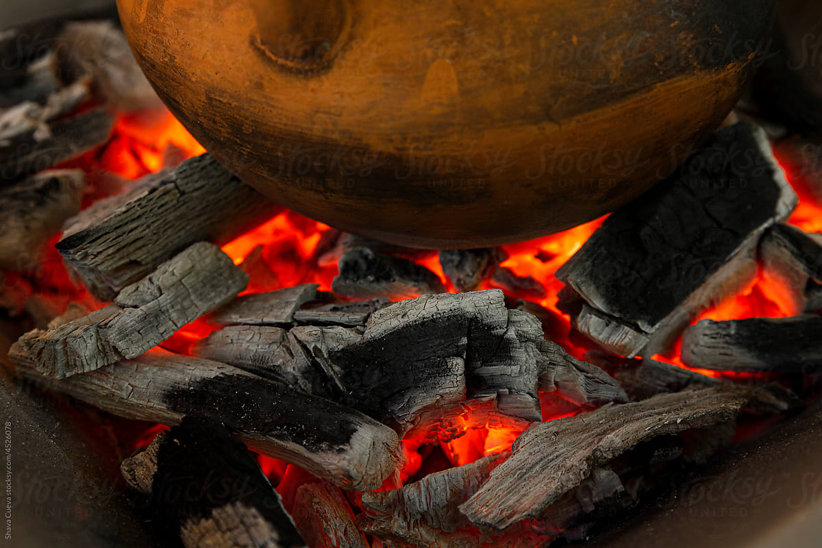 Closeup of a wooden pot over burning coals