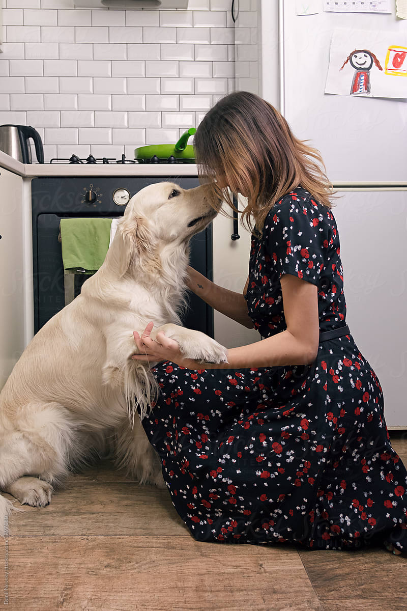 Female with dog in the kitchen