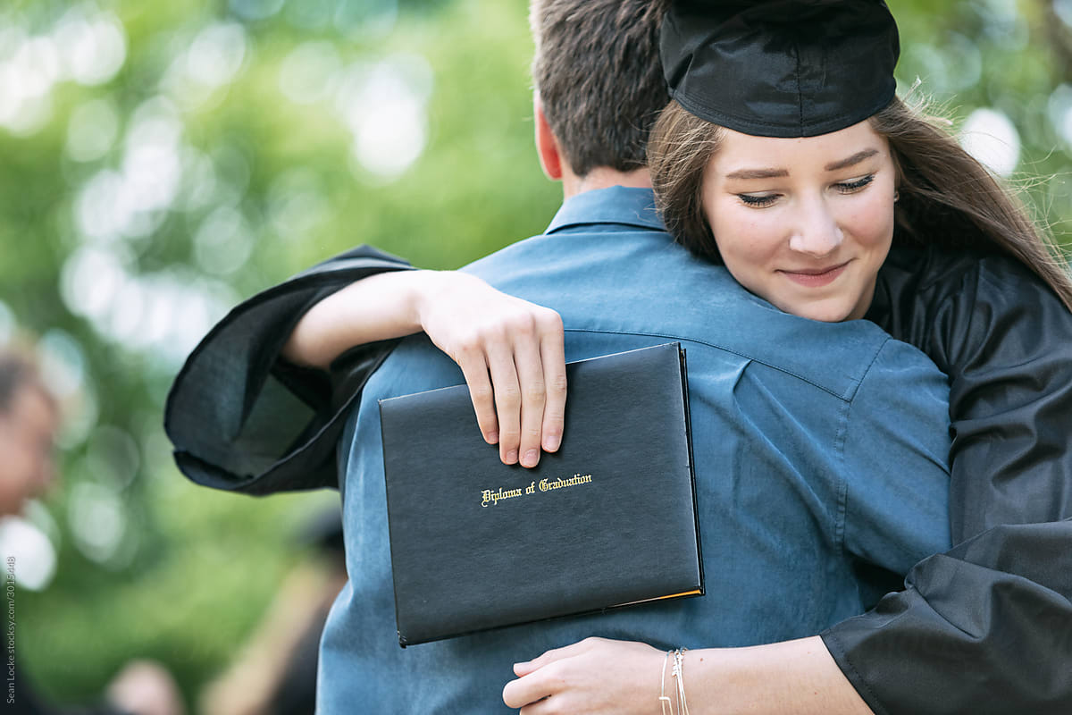 Grad: Proud Parent Hugs New Graduate