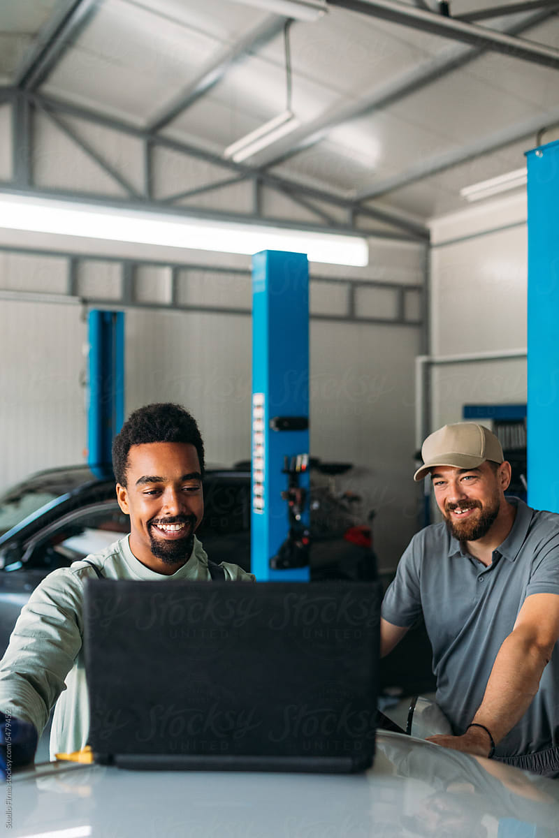 Men Working in Garage, Using Laptop for Diagnostic