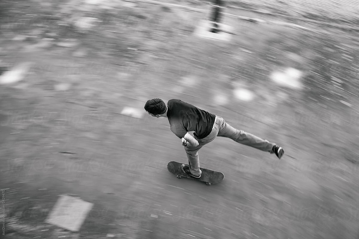 Young Man Skateboarding in the Streets