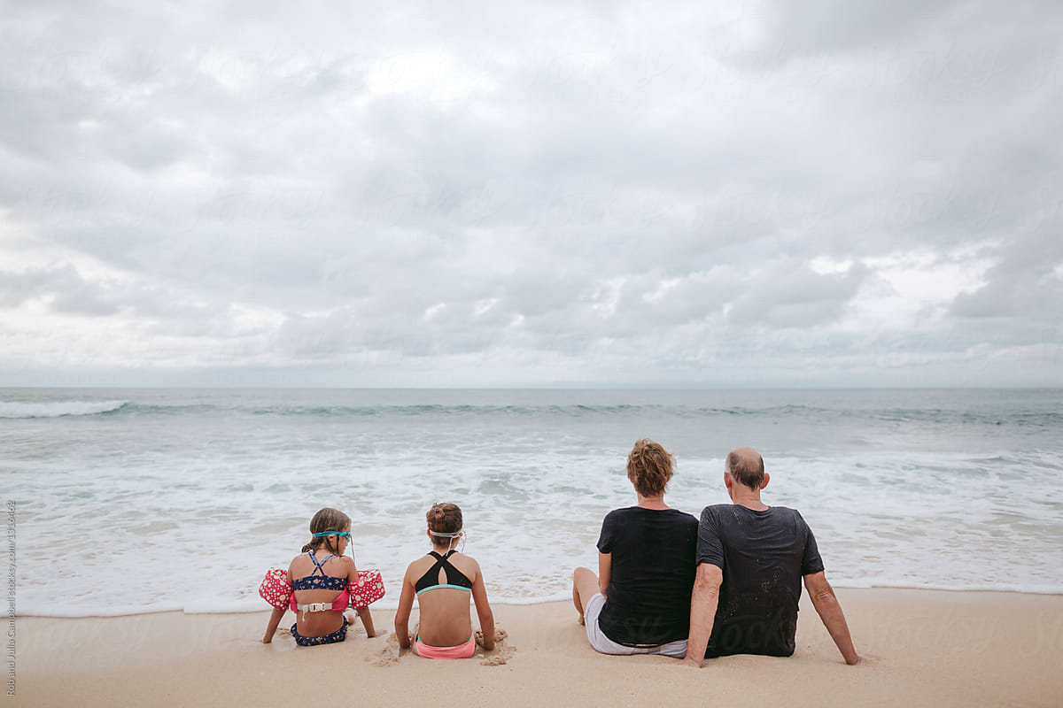 Grandparents spending quality time with kids on beach holiday