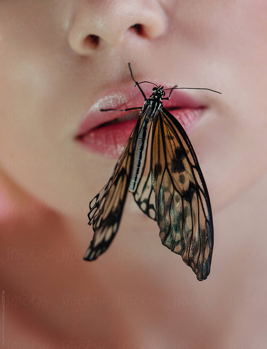 Butterfly sitting on juicy lips