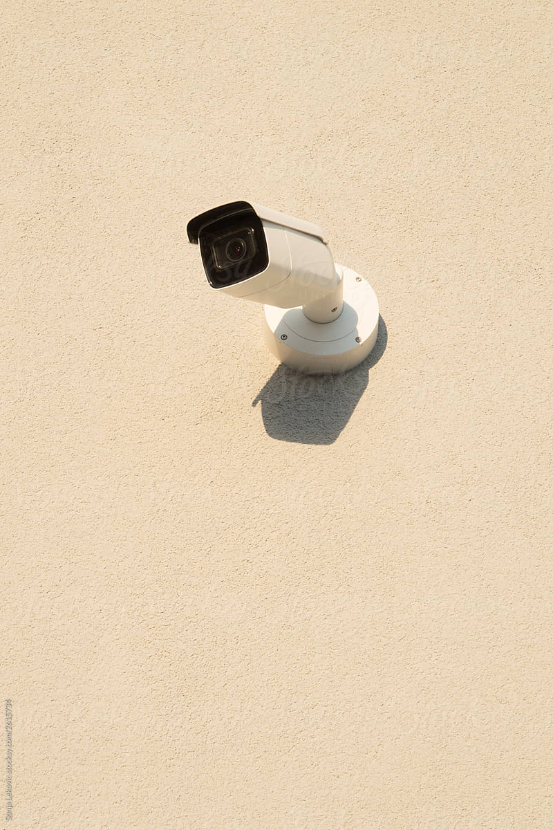 security surveillance camera on beige wall