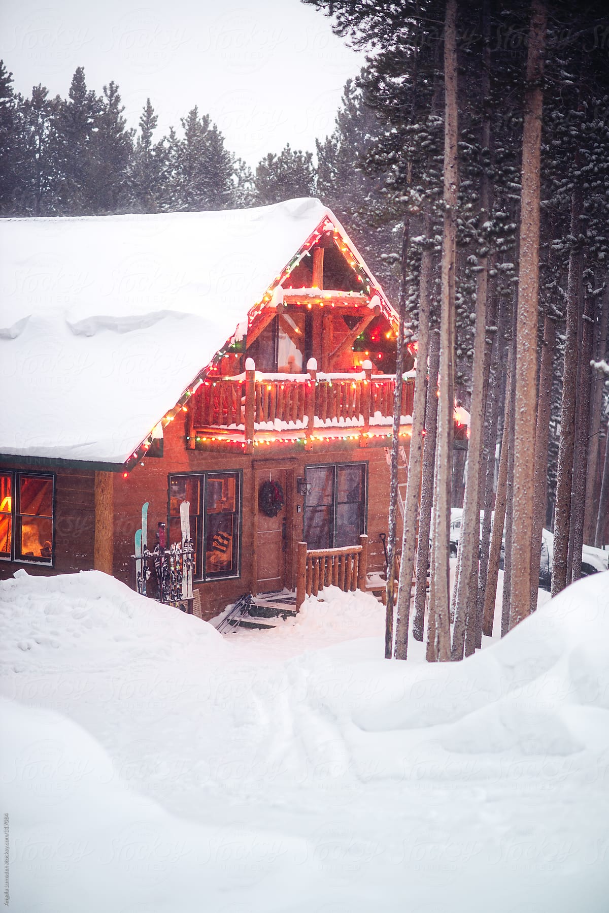 Ski cabin surrounded by deep snow and pine trees