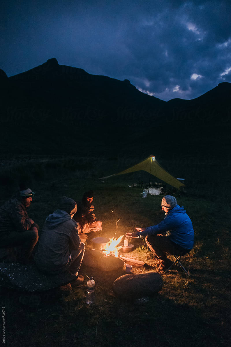 Friends around an outdoor campfire
