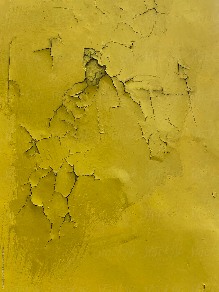 Cracked yellow color background on metallic surface