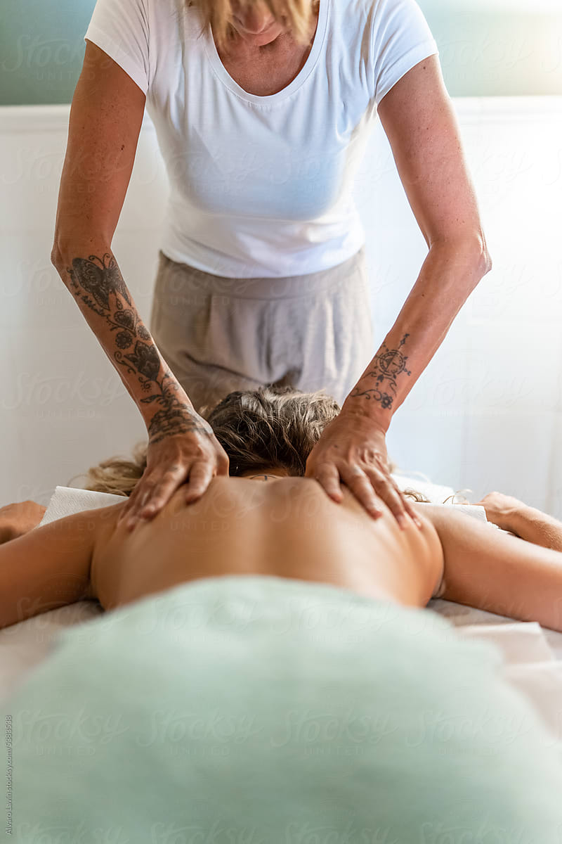 energy masseuse giving relaxing massage to client