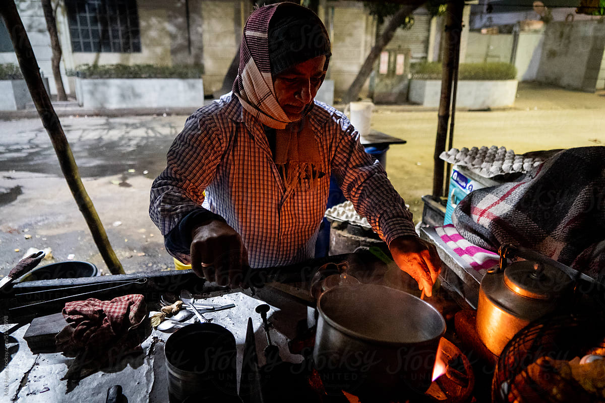 A street food vendor boils water for hot chai tea in Kolkata