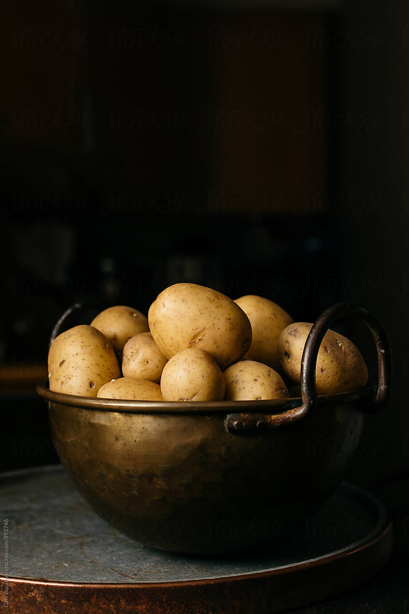 Brass bowl with potatoes