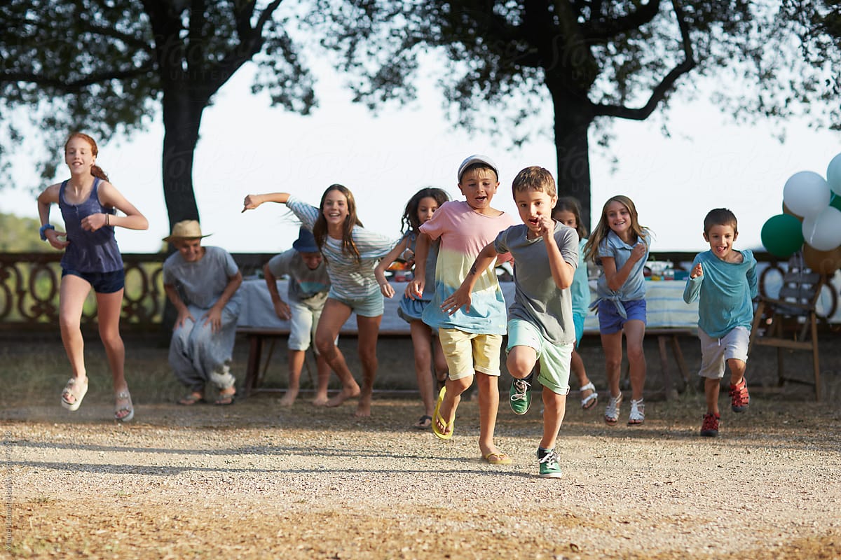 Group of children running at an outdoors party