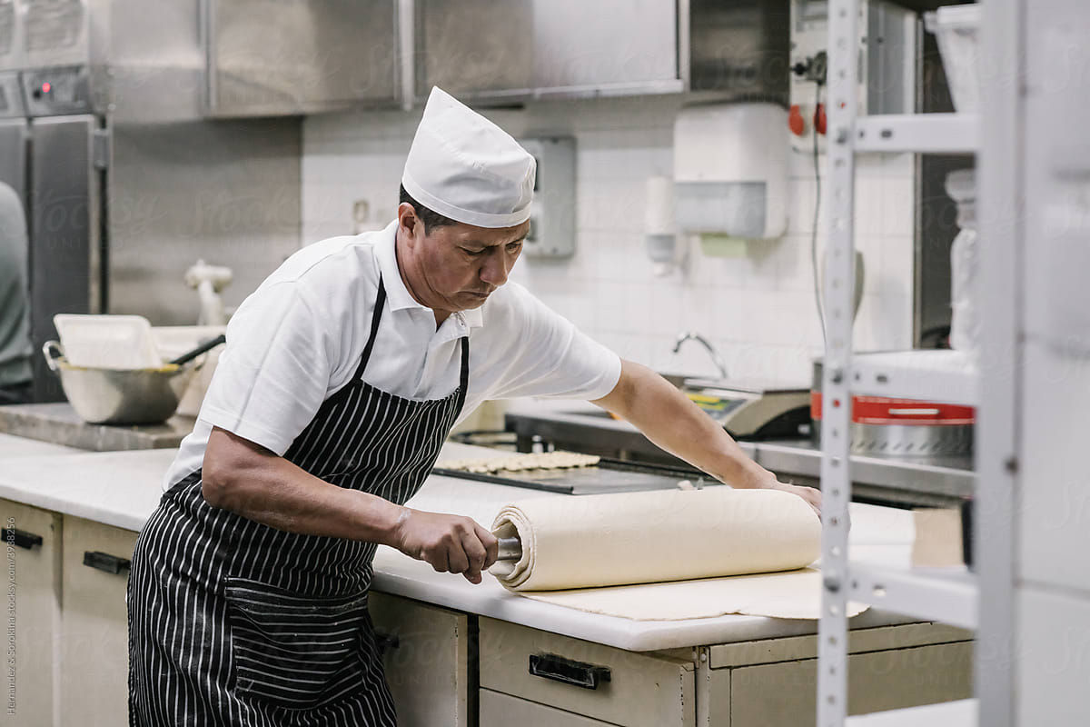Baker Working With Dough At Bakery