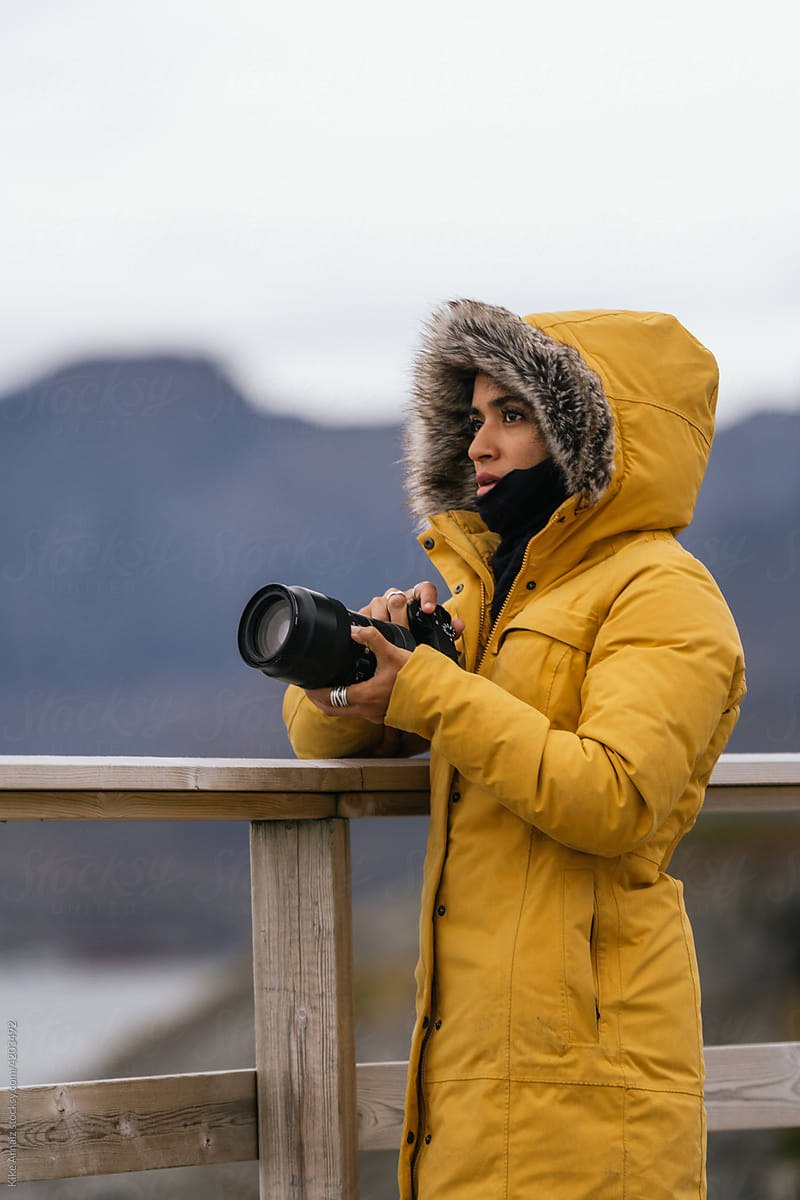 Arabic female photographer admiring mountains and lake
