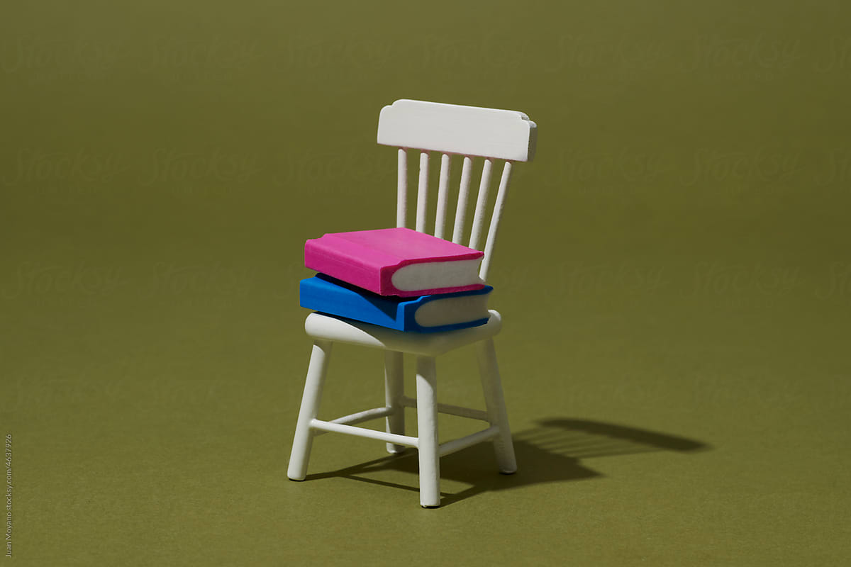 a pile of books on a chair