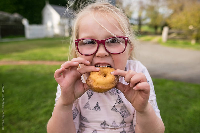 Cheeky kid eating a donut