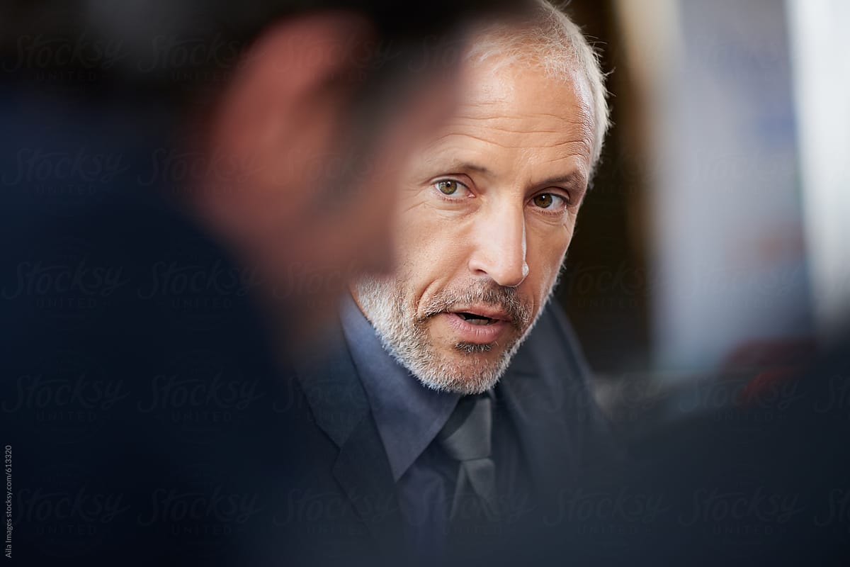 portrait of mature businessman having serious determined meeting