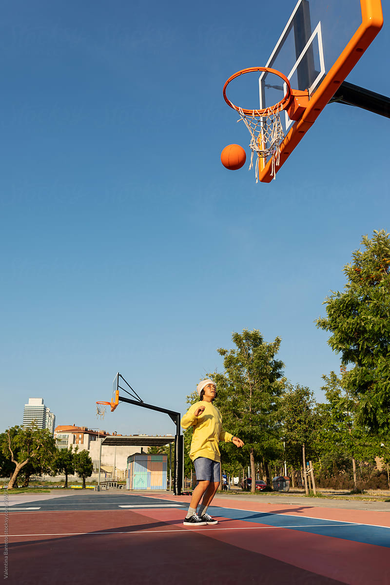 Boy throwing the ball to the basket