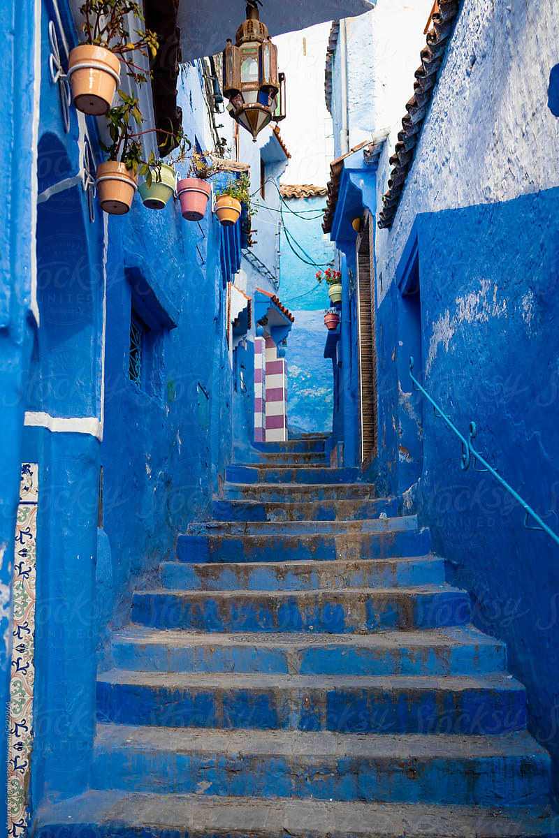 Stairway between buildings painted in blue