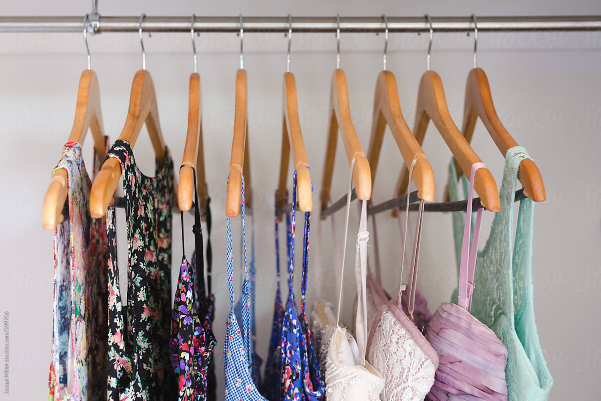 Cute summer dresses on hangers in a wardrobe