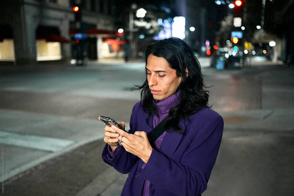 Latino male texting in the city