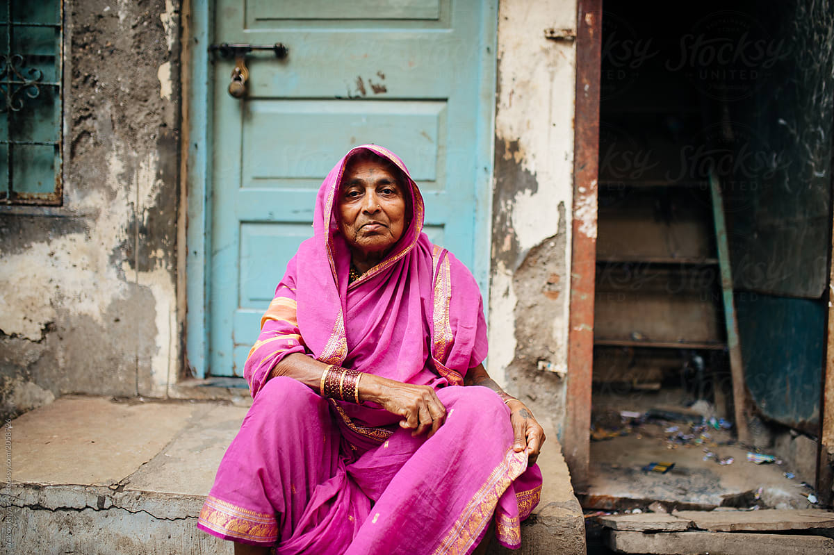 aged Indian woman in a fuchsia outfit
