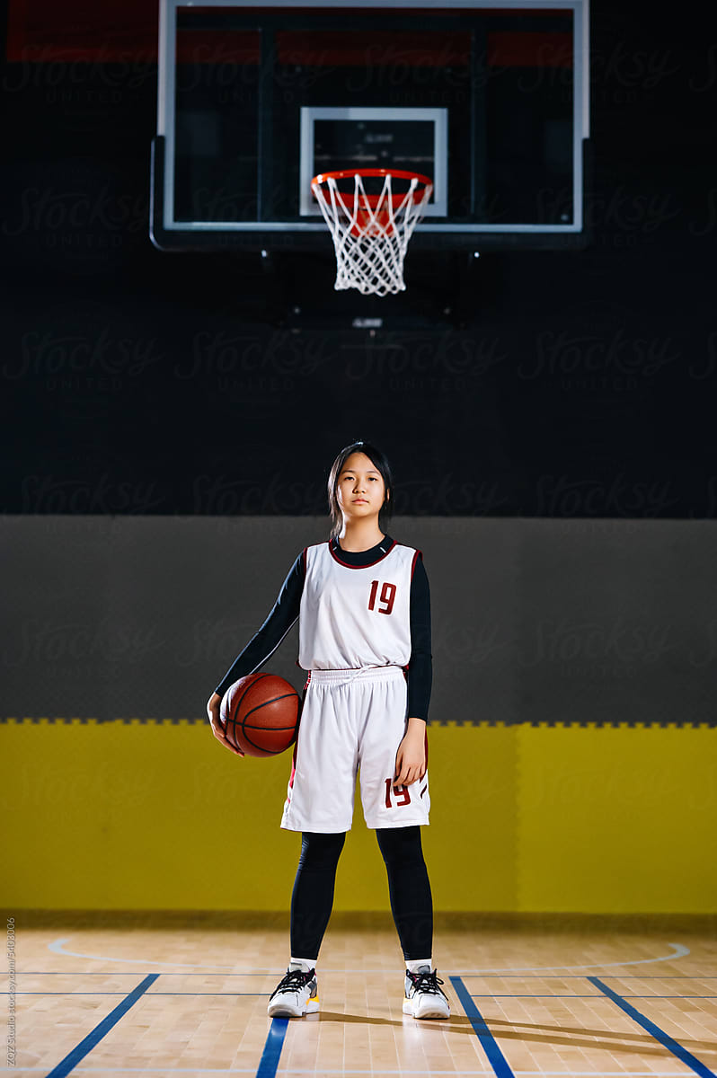 Portrait of basketball girl smiling in a gym
