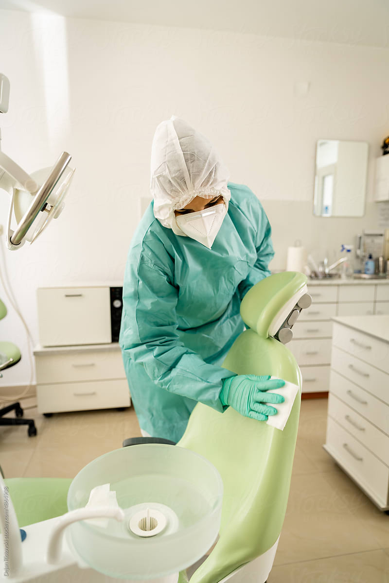 Assistant disinfects  after patient in dental clinic