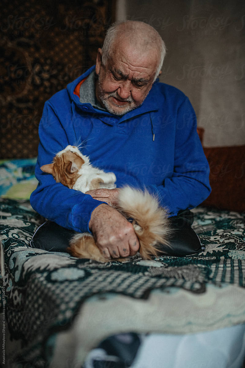 Physically Disabled Man Petting His Cat in the bedroom