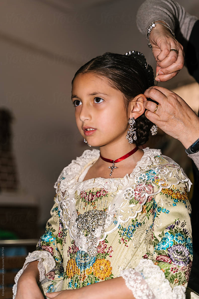 Woman doing girls hair for Las Fallas celebration