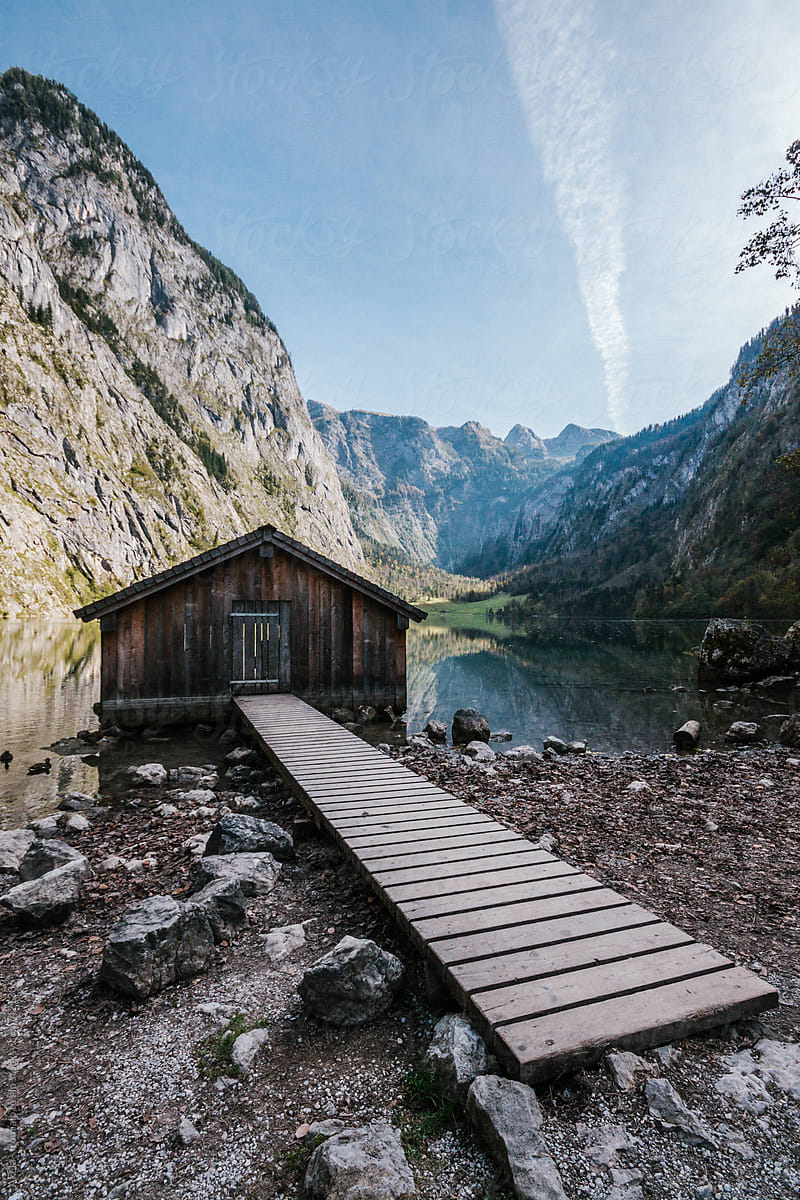 wooden alpine shack with jetty on a mountain lake in the bavarian alps