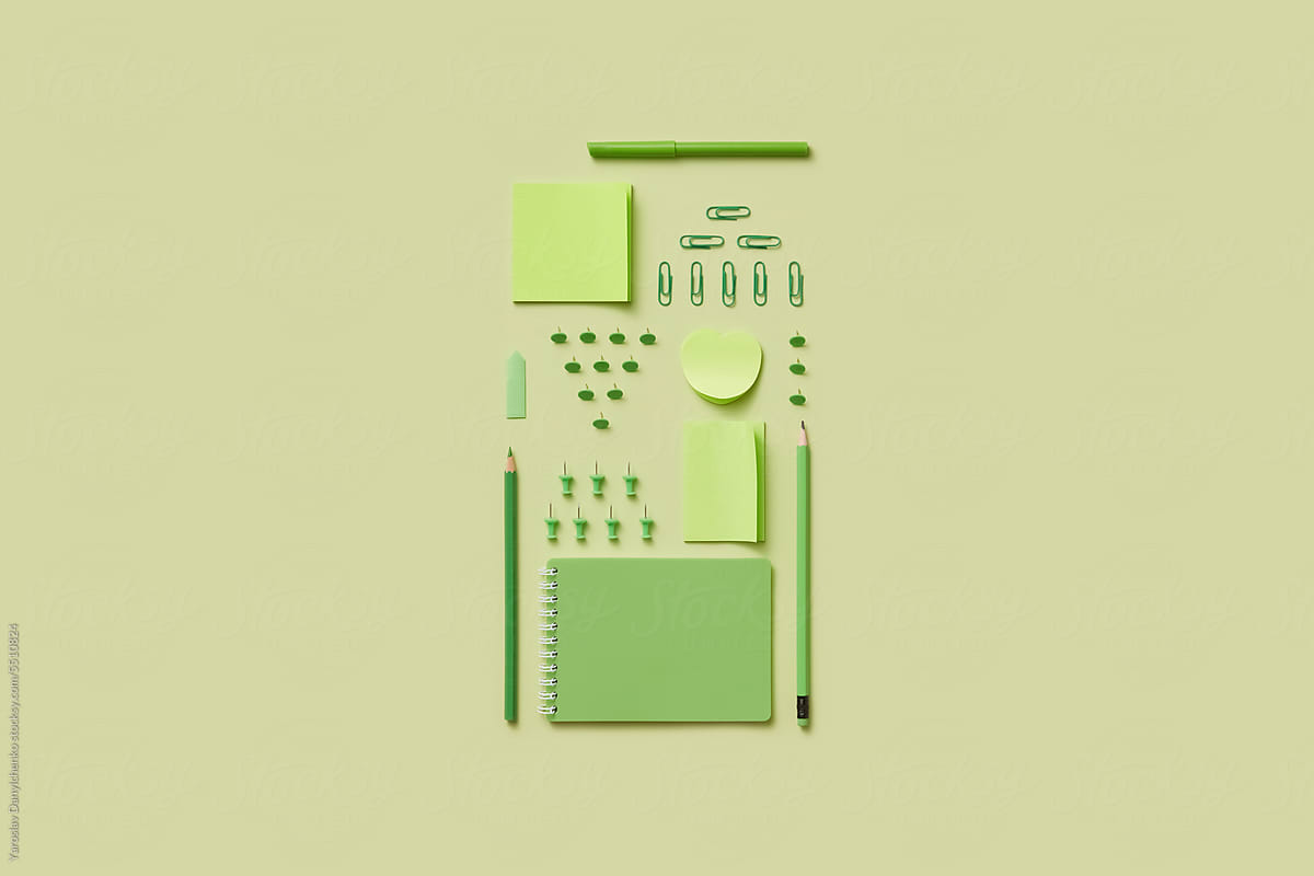 Flat lay of green-colored office supplies.