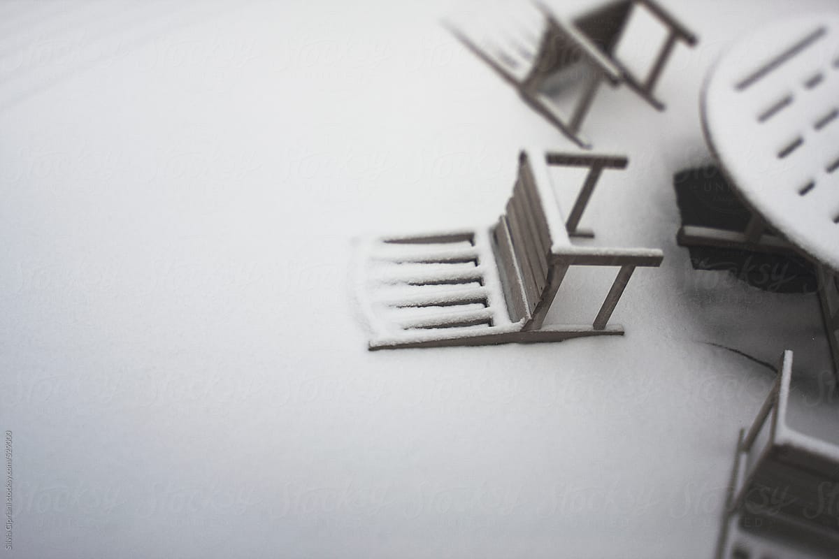 Snow-covered fallen chairs