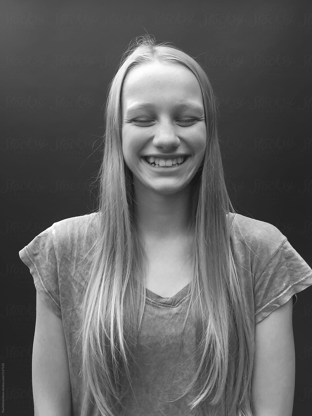 Portrait of teenage girl laughing, eyes closed