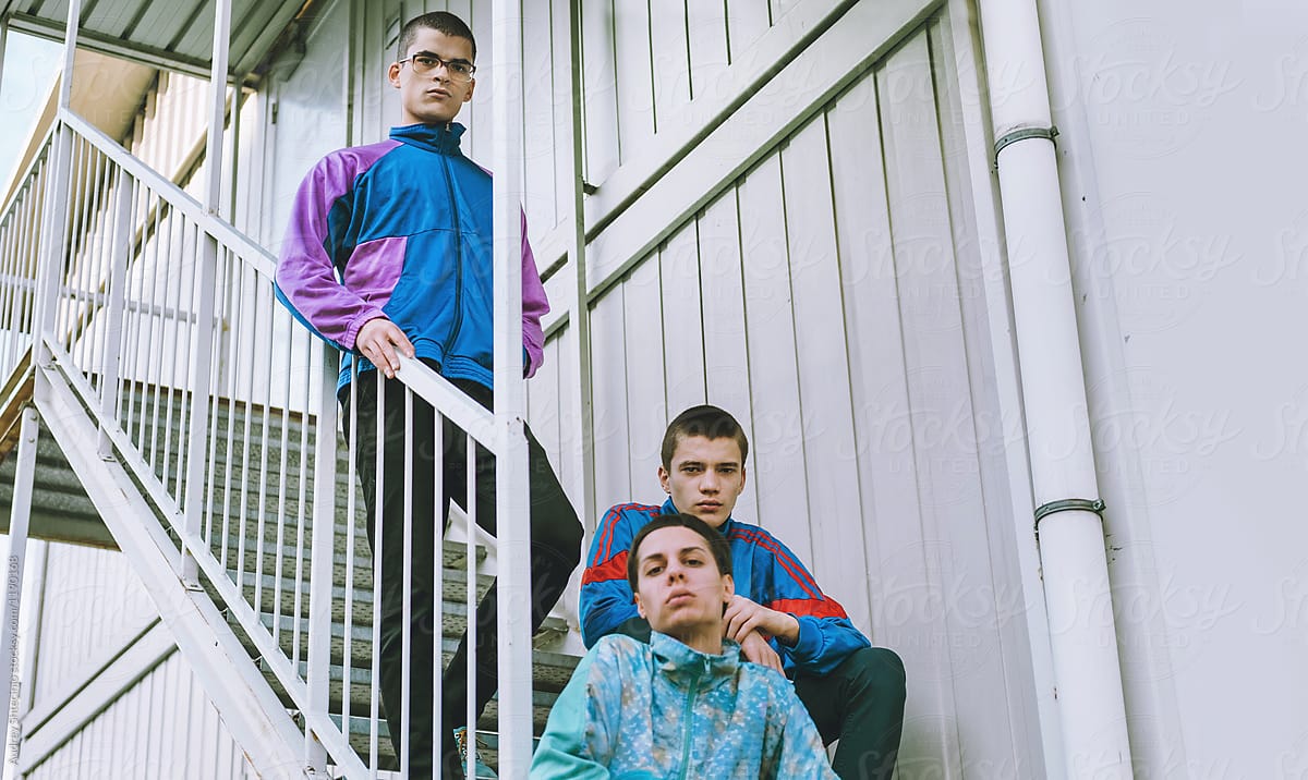 Young adolescents in colorful  track suits from 90\'s in east Europe projects.