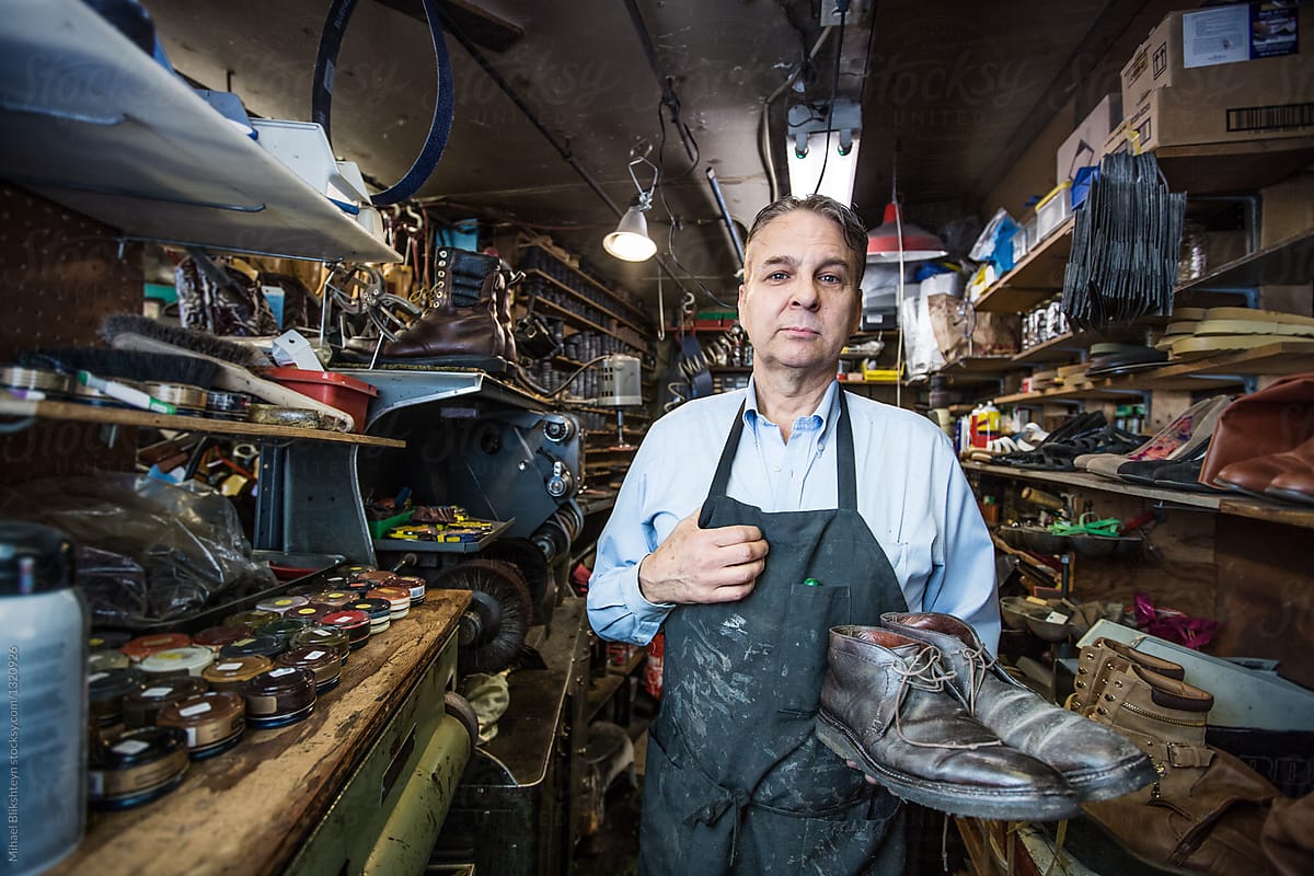 Portrait of a cobbler in his shoe repair shop