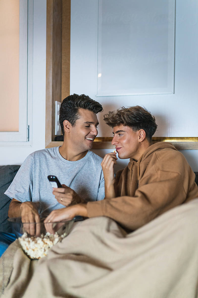 Gay couple watching a movie at home
