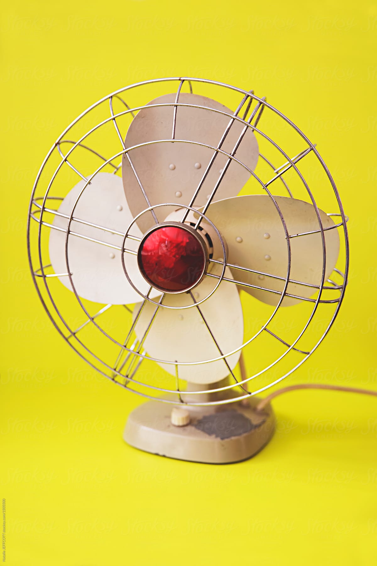 Retro cooling fan on yellow background