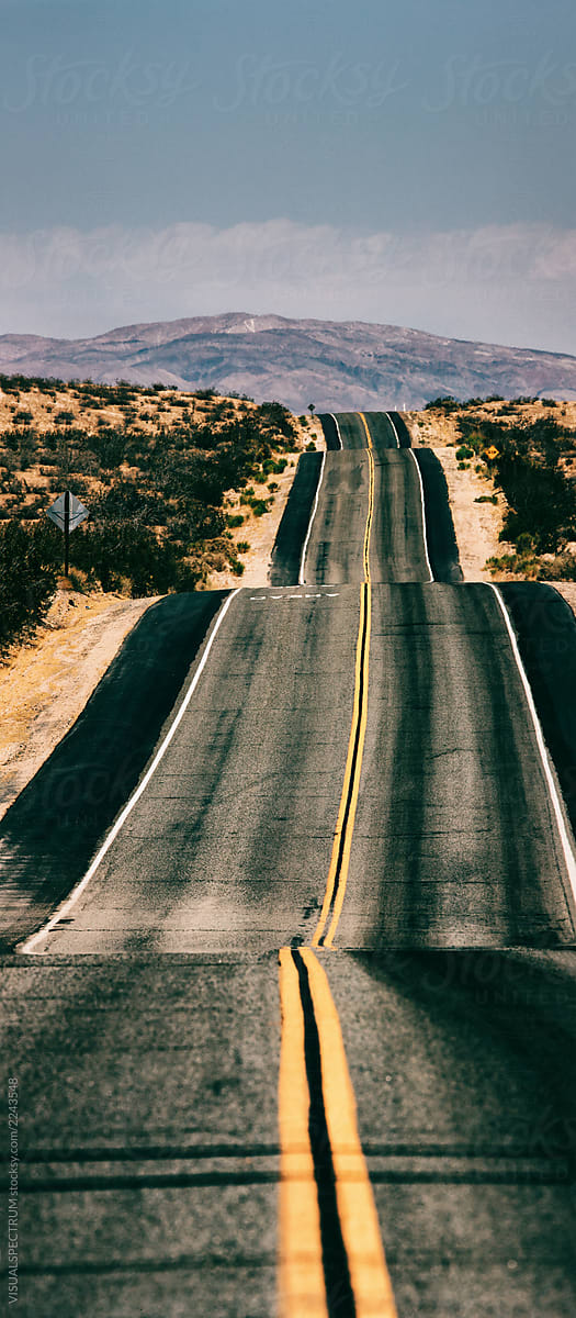 Very Long Straight Road Through California Desert Landscape