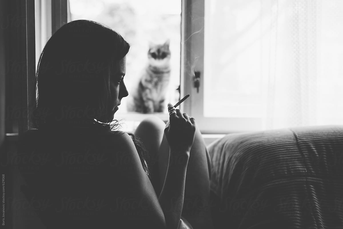 Young Woman In Lingerie Smoking A Cigarette By The Window | Stocksy United