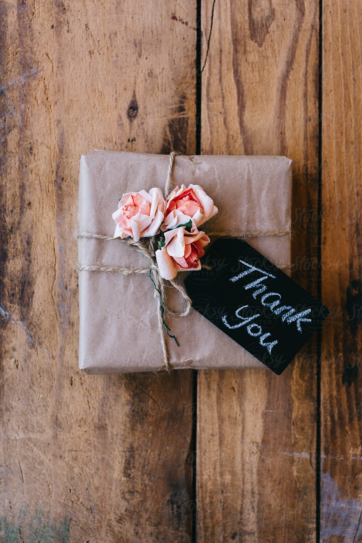 Rustic gift with slate tag with the word \'thank you\' written on it
