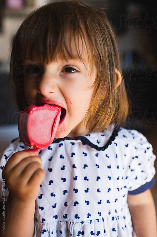 Funny little girl eating an ice-cream